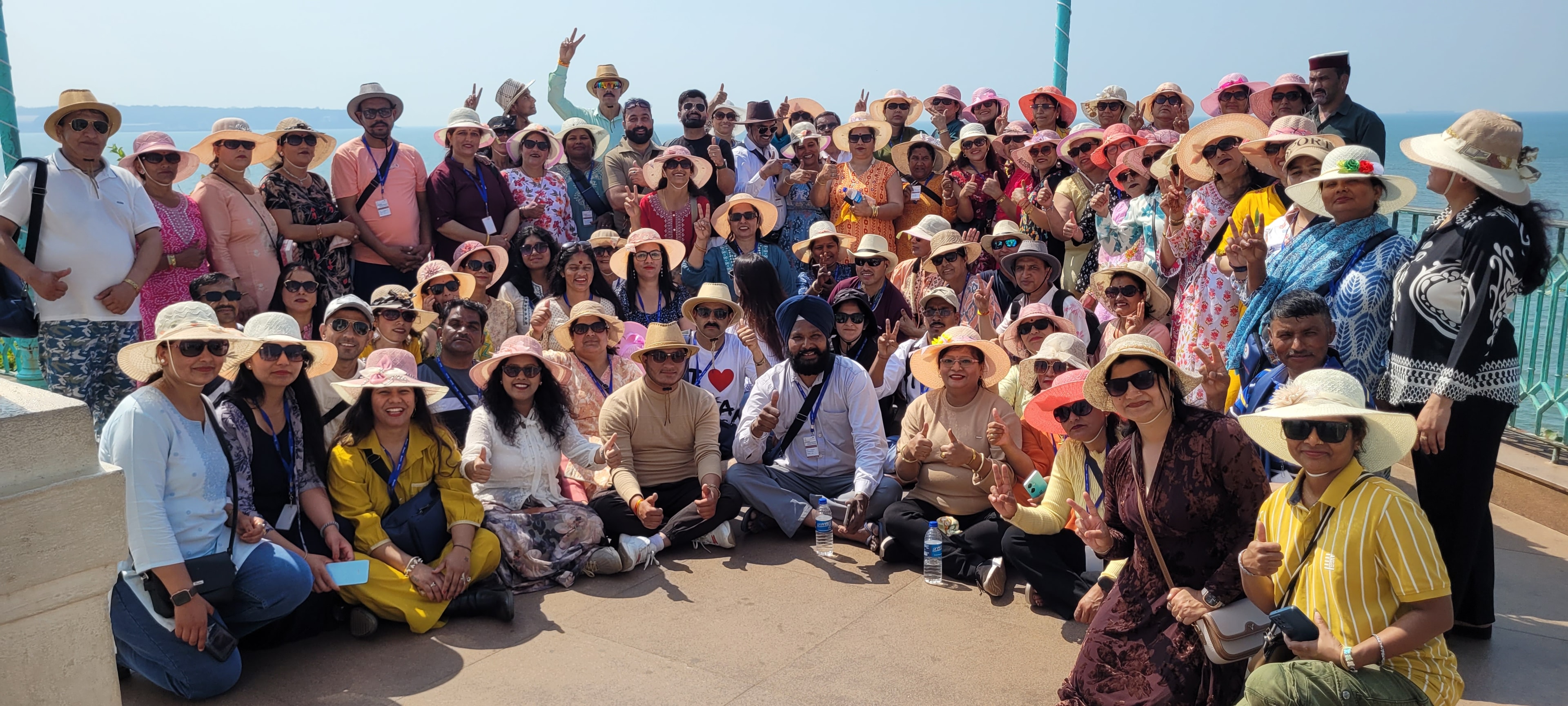 120 pax network marketing group at Goa beach in sun hats