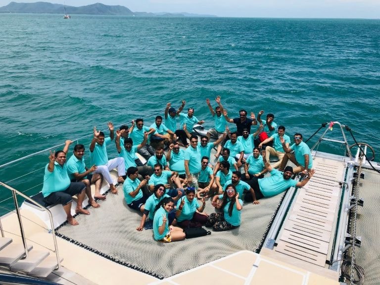 40 pax group on a private yacht in Pattaya wearing matching teal shirts